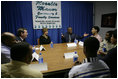 Laura Bush Secretary of Health and Human Services Mike Leavitt listen to Alphonso Pettis, Case Manager for Today's Dad's at Rosalie Manor Community and Family Services center in Milwaukee, Wis, Tuesday, March 8, 2005. Mr. Pettis is explaining in detail the pride he feels regarding the achievements of the young men sitting at the table, who, as teen fathers, have finished high school and found jobs.