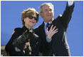 Mrs. Bush holds onto Miss Beazley Monday, March 28, 2005, as she and President George W. Bush wave goodbye upon boarding Air Force One in Waco, Texas, en route home to Washington D.C.