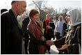 First lady Laura Bush and Margaret Spellings, Secretary of Education, center, stand with Afghan President Hamid Karzai Wednesday, March 30, 2005, after their arrival in Kabul.