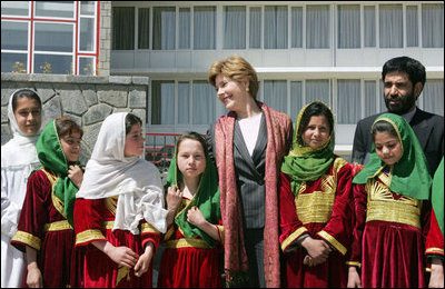 Mrs. Laura Bush stands with a group of Afghan girls on hand to greet her Wednesday, March 30, 2005, upon her arrival in Kabul.