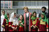 Mrs. Laura Bush stands with a group of Afghan girls on hand to greet her Wednesday, March 30, 2005, upon her arrival in Kabul.