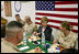 Laura Bush laughs with troops as they eat dinner in the Dragon Chow Dining Hall on Bagram Air Base in Kabul, Afghanistan Wednesday, March 30, 2005.