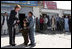 Laura Bush shows youngsters how to use a kaleidoscope outside a Kabul bakery after a stop Wednesday, March 30, 2005. The toys were gifts from the White House given by the first lady during her brief visit to Afghanistan.