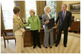 President George W. Bush and Laura Bush meet with Barbara de Marneff and Stephanie Copeland of Edith Wharton Restoration in Massachusetts, in the Oval Office Monday, May 2, 2005. The two women are two of the recipients of the 2005 Preserve America Presidential Award.