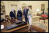 President George W. Bush and Laura Bush discuss some of the history of the Oval Office Agnes Chouteau, left, and Lorraine Stange both of Missouri Monday, May 2, 2005. The two women are recipients of the 2005 Preserve America Presidential Award.