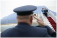 President George W. Bush returns a salute from Brigadier General David S. Gray, Commander, 89th Airlift Wing as he and Mrs Bush board Air Force One before departing Andrews Air Force Base for Latvia, Friday, May 6, 2005.