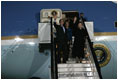 Waving to the crowd, President and Mrs. Bush and Latvia's President Vaira Vike-Freiberga deplane Air Force One Friday night, May 6, 2005, after the Bushes arrived in Riga, Latvia for the first of four European stops.