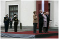 President George W. Bush and Laura Bush and Latvia President Vaira Vike-Freiberga and husband Imants Freibergs stand for the playing of the American national anthem Saturday, May 7, 2005, at Riga Castle in Riga, Latvia.