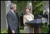 Laura Bush looks over to President Bush during a Rose Garden announcement honoring the 2005 Preserve America Presidential Awards Winners Monday, May 2, 2005. "These awards recognize collaborative efforts to protect and enhance our nation's cultural and historical heritage," said Mrs. Bush in her remarks.