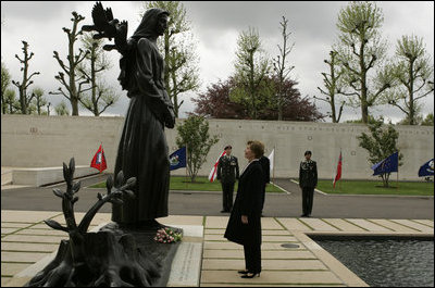 First Lady Laura Bush reflects after placing flowers at the Mourning Woman Statue in Netherlands American Cemetery Sunday, May 8, 2005, in Margraten.