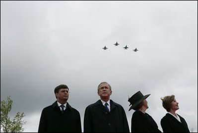 Jan Peter Balkenende, Prime Minister of The Netherlands, left, President George W. Bush, Queen Beatrix of The Netherlands, and Mrs. Laura Bush stand on stage Sunday, May 8, 2005, at the Netherlands American Cemetery in Margraten, as a flyover marks the remembrance of those who served in World War II.