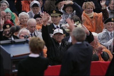 President George W. Bush and Mrs. Bush wave to a crowd at the American Cemetery in Margraten, Netherlands Sunday, May 8, 2005, honoring those who served in World War II 60 years ago.