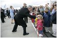 Greeted by flowers and smiles, President George W. Bush returns the gesture during his and Laura Bush's arrival in Maastricht, Netherlands, May 7, 2005.