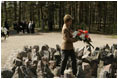 Laura Bush lays flowers at the Rumbula Holocaust Memorial in Riga, Latvia, Saturday, May 7, 2005.