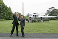 President George W. Bush and Laura Bush wave to the NCAA champions on the Truman balcony before departing the South Lawn en route Camp David Friday, May 13, 2005.