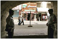 Jordanians guard the Haret Jdouna restaurant in Madaba, Jordan, as Laura Bush has lunch with Jordanian women leaders to discuss women’s rights Saturday, May 21, 2005.