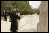 Father Michele Piccirillo, head of the Franciscan Archeology Society, discusses a monument with Laura Bush during her tour of Mount Nebo in Jordan Saturday, May 21, 2005.