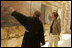 Father Michele Piccirillo, head of the Franciscan Archeology Society, gives Laura Bush a tour of the Interpretative Center at Mount Nebo in Jordan Saturday, May 21, 2005. Mount Nebo is the holy site where Moses is believed to have died.