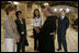 Laura Bush talks with Father Michele Piccirillo, head of the Franciscan Archeology Society, Chief of Staff Anita McBride, second on left, and Queen Rania al-Abdullah, center, in the Basillica on top of Mount Nebo in Jordan Saturday, May 21, 2005.