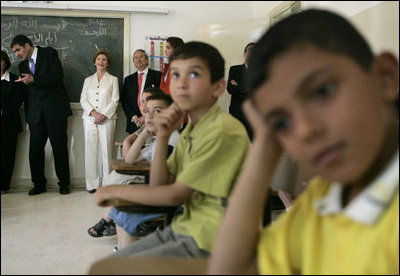 Laura Bush joins students in watching a kids educational program at the Discovery School of Swaifiyeh Secondary School in Amman, Jordan, Sunday, May 22, 2005.