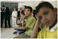 Laura Bush joins students in watching a kids educational program at the Discovery School of Swaifiyeh Secondary School in Amman, Jordan, Sunday, May 22, 2005.