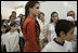 Queen Raina Al-Abdullah, wife of King Abdullah of Jordan, center, and Laura Bush listen to a computer lab presentation at the Discovery School of Swaifiyeh Secondary School in Amman, Jordan, Sunday, May 22, 2005. The school is one of 100 in the country that have developed Internet curriculum to help reform Jordanian education.