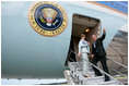 President George W. Bush gives the thumbs-up Saturday, November 5, 2005, as he and Mrs. Laura Bush board Air Force One in Mar del Plata after attending the 2005 Summit of the Americas. The President and First Lady traveled to Brasilia where they will spend Sunday visiting with President Luis Inacio Lula Da Silva.