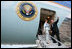 President George W. Bush gives the thumbs-up Saturday, November 5, 2005, as he and Mrs. Laura Bush board Air Force One in Mar del Plata after attending the 2005 Summit of the Americas. The President and First Lady traveled to Brasilia where they will spend Sunday visiting with President Luis Inacio Lula Da Silva.