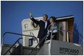 President George W. Bush and Laura Bush wave from Air Force One after landing Thursday, Nov. 3, 2005, in Mar del Plata, Argentina, where the President will participate in the Summit of the Americas.