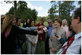 Mrs. Laura Bush smiles as she talks with the media after lunching Friday, Nov. 4, 2005, at Estancia Santa Isabel, an Argentine ranch located not far from Mar del Plata, where President George W. Bush was participating in the 2005 Summit of the Americas.