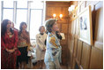 Mrs. Laura Bush looks over a photographic exhibit during a luncheon in Mar del Plata Saturday, Nov. 5, 2005, hosted by Argentine First Lady Mrs. Cristina Fernandez de Kirchner, far left.