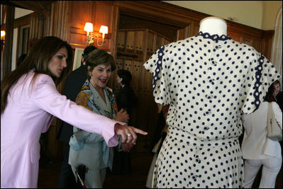 Mrs. Laura Bush is shown a dress worn by former Argentine First Lady Eva Peron as the U.S. First Lady participated in a luncheon Saturday, Nov. 5, 2005, in Mar del Plata that included a display of important Argentine women.