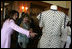 Mrs. Laura Bush is shown a dress worn by former Argentine First Lady Eva Peron as the U.S. First Lady participated in a luncheon Saturday, Nov. 5, 2005, in Mar del Plata that included a display of important Argentine women.