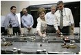 Laura Bush with President George W. Bush turns a knob during a tour of the operations center of the Panama Canal's Miraflores Locks in Panama City, Panama, Monday, Nov. 7, 2005.