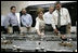 Laura Bush with President George W. Bush turns a knob during a tour of the operations center of the Panama Canal's Miraflores Locks in Panama City, Panama, Monday, Nov. 7, 2005.