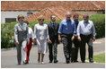 President George W. Bush and Brazil President Luiz Inacio Lula da Silva are joined by their wives, Laura Bush and Marisa Leticia da Silva, as they walk the grounds of President da Silva's Granja do Torto Saturday, Nov. 6, 2005.