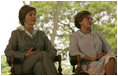 Mrs. Laura Bush and Mrs. Marisa Leticia da Silva listen to remarks by their husbands, during a joint statement at Granja do Torto, home of Brazil President Luiz Inacio Lula da Silva, Saturday, Nov. 6, 2005.