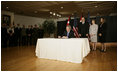 President George W. Bush signs a book of condolence, Thursday, Nov. 10, 2005 at the Embassy of Jordan in Washington, in remembrance of those killed in the terrorist attacks, Wednesday, in Jordan.