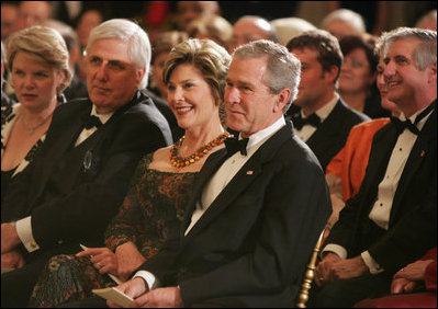 President George W. Bush and Mrs. Laura Bush listen to the evening's entertainment at the White House, Thursday, Nov. 10, 2005, following the dinner celebrating the 40th Anniversary of the National Endowment for the Arts and the National Endowment for the Humanities.