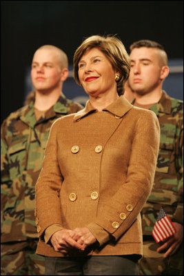 Mrs. Laura Bush smiles as she listens to the President’s introduction Monday, Nov. 14, 2005, at Elmendorf Air Force Base in Anchorage, Alaska, where he delivered remarks on the War on Terror to the troops.