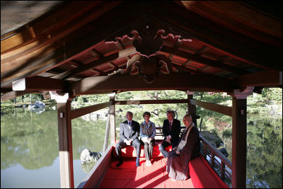 President George W. Bush, Mrs. Bush, Japan’s Prime Minister Junichiro Koizumi and the Reverend Raitei Arima, Chief Priest of the Golden Pavilion Kinkakuji Temple, share a light moment during a cultural visit to the temple Wednesday, Nov. 16, 2005, in Kyoto.