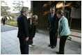 President and Mrs. Bush are greeted by the Reverend Raitei Arima, Chief Priest at the Golden Pavilion Kinkakuji Temple, and Japan’s Prime Minister Junichiro Koizumi, at the doors of the temple Wednesday, Nov. 16, 2005, in Kyoto.