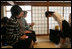 Mrs. Laura Bush accepts a cup of tea from a student in the Tea Ceremony Classroom at Doshisha Girls Junior High School and Senior High School during her visit Wednesday, Nov. 16, 2005, to Kyoto, Japan. With Mrs. Bush are Susanne Schieffer, wife of U.S. Ambassador Thomas Schieffer, and Mrs. Hanayo Kato, wife of Japanese Ambassador Ryozo Kato.