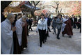 President George W. Bush and Laura Bush smile as they are greeted by monks Thursday, Nov. 17, 2005, at the Bulguksa Temple in Gyeongju, Korea.