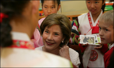 Laura Bush listens to children in the Children's Reading Room of the Busan Simin Metropolitan Municipal Library Friday, Nov. 18, 2005, in Busan, Korea.