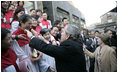 President George W. Bush reaches out to church members Sunday, Nov. 20, 2005, at the Gangwashi Church in Beijing after he and Mrs. Bush attended services.