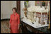 Laura Bush stands before the White House gingerbread house , Wednesday, Nov. 30, 2005, as she answers questions during the press preview of the White House Christmas decorations.