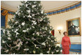 Laura Bush stands next to the Blue Room Christmas tree, Wednesday, Nov. 30, 2005, as she answers questions during the press preview of the White House Christmas decorations.