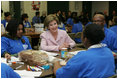 Laura Bush talks with students Wednesday, Nov. 30, 2005 during a visit to the Church of the Epiphany in Washington, as part of her Helping America's Youth initiative, where the students, part of the Youth Service Learning Project, were preparing sandwiches to feed the homeless.