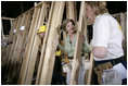 Laura Bush helps push a support wall into place, Tuesday, Oct. 11, 2005, while visiting a Habitat for Humanity building site in Covington, La., where homes are being built for victims of Hurricane Katrina.